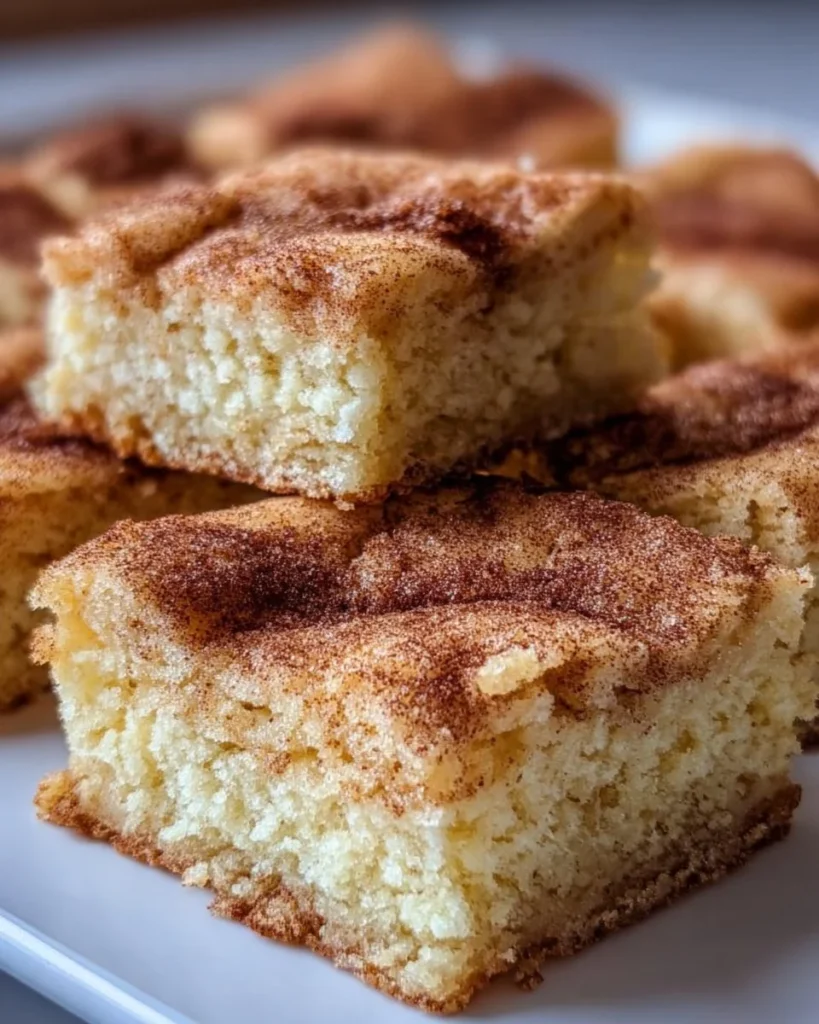 Delicious chewy snickerdoodle cookie bars topped with cinnamon sugar.