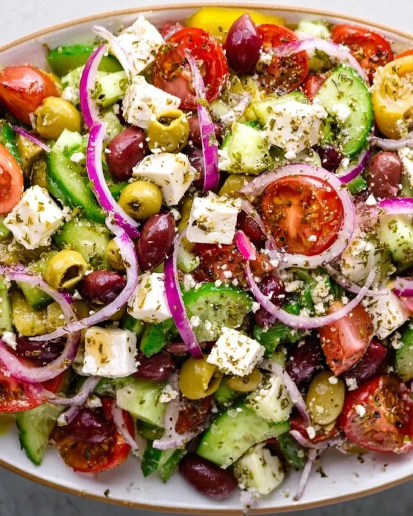 A vibrant and fresh Greek salad with vegetables, feta cheese, and olives.