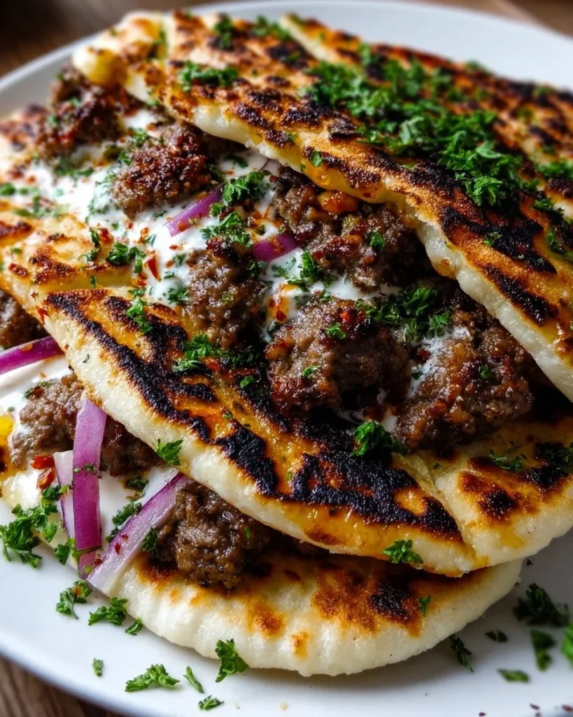 Delicious grilled lamb pita arayes served on a plate with fresh herbs