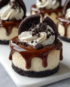 Oreo chocolate mini cheesecakes topped with crushed Oreos and a creamy filling