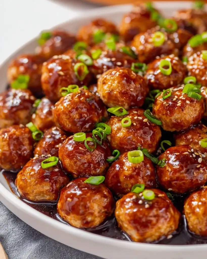 Asian Turkey Meatballs served with a savory sauce and garnished with scallions