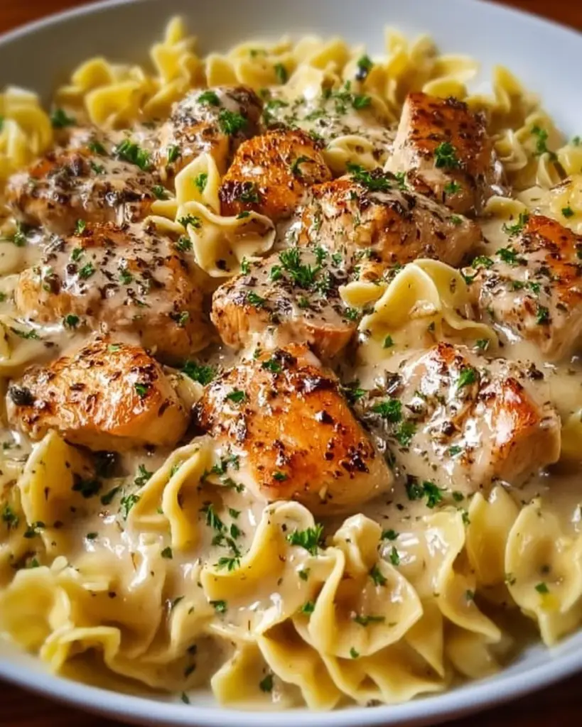 One-Pan Creamy Garlic Butter Chicken served with Egg Noodles, a delicious meal.