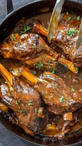 Braised Lamb Shanks in red wine gravy served with sides