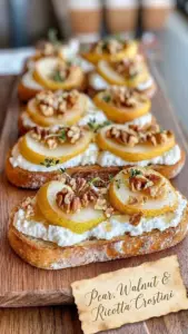 Pear, walnut, and ricotta crostini on a wooden serving board