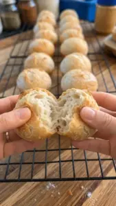Mini sourdough boules baked in a cupcake pan for easy serving.
