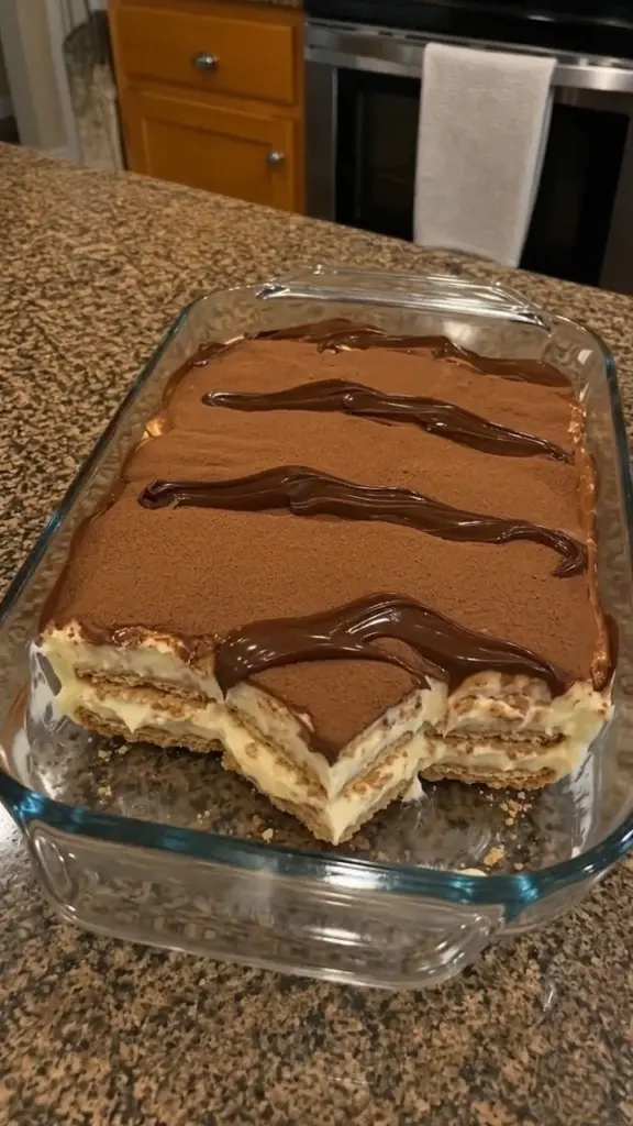 No-Bake Éclair Cake with chocolate glaze and layers of cream filling