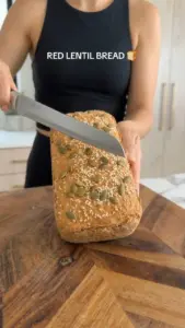 Freshly baked red lentil bread on a wooden cutting board