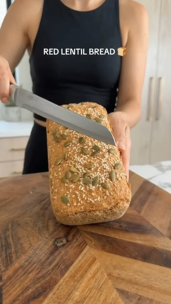 Freshly baked red lentil bread on a wooden cutting board