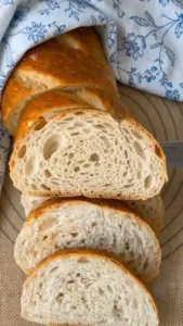 Freshly baked same-day sourdough discard bread on a wooden table